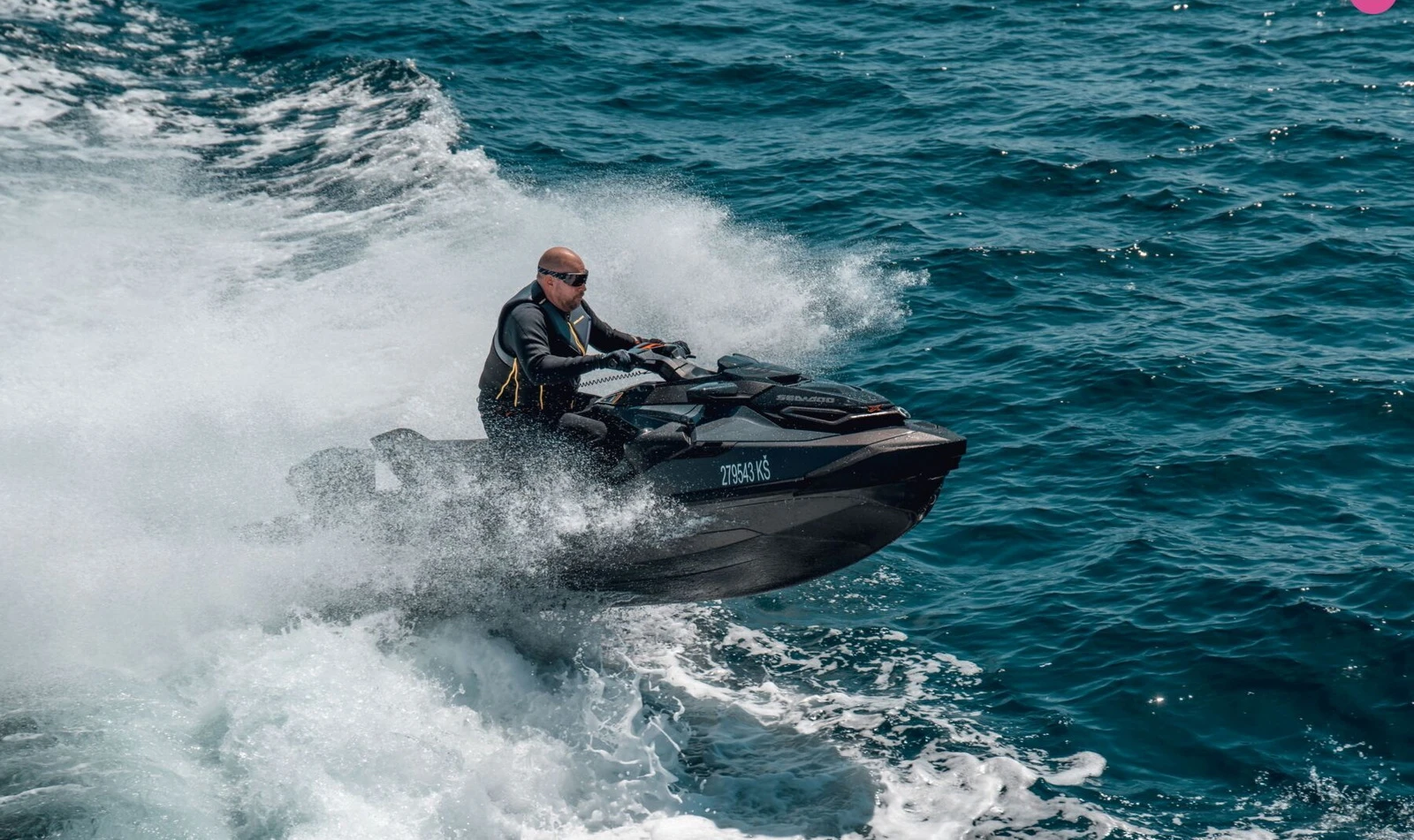 Powerful black jet ski cutting through the waves