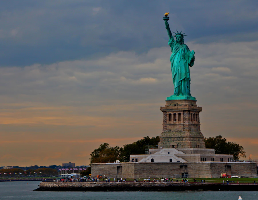 Statue of Liberty under a dramatic evening sky