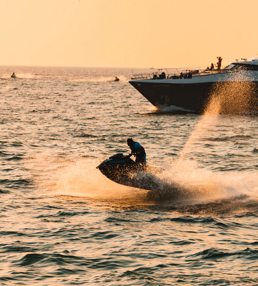 Jet ski rider throwing spray at sunset