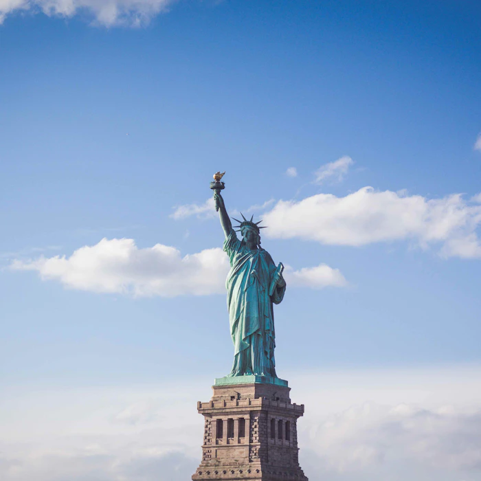Statue of Liberty against a bright blue sky